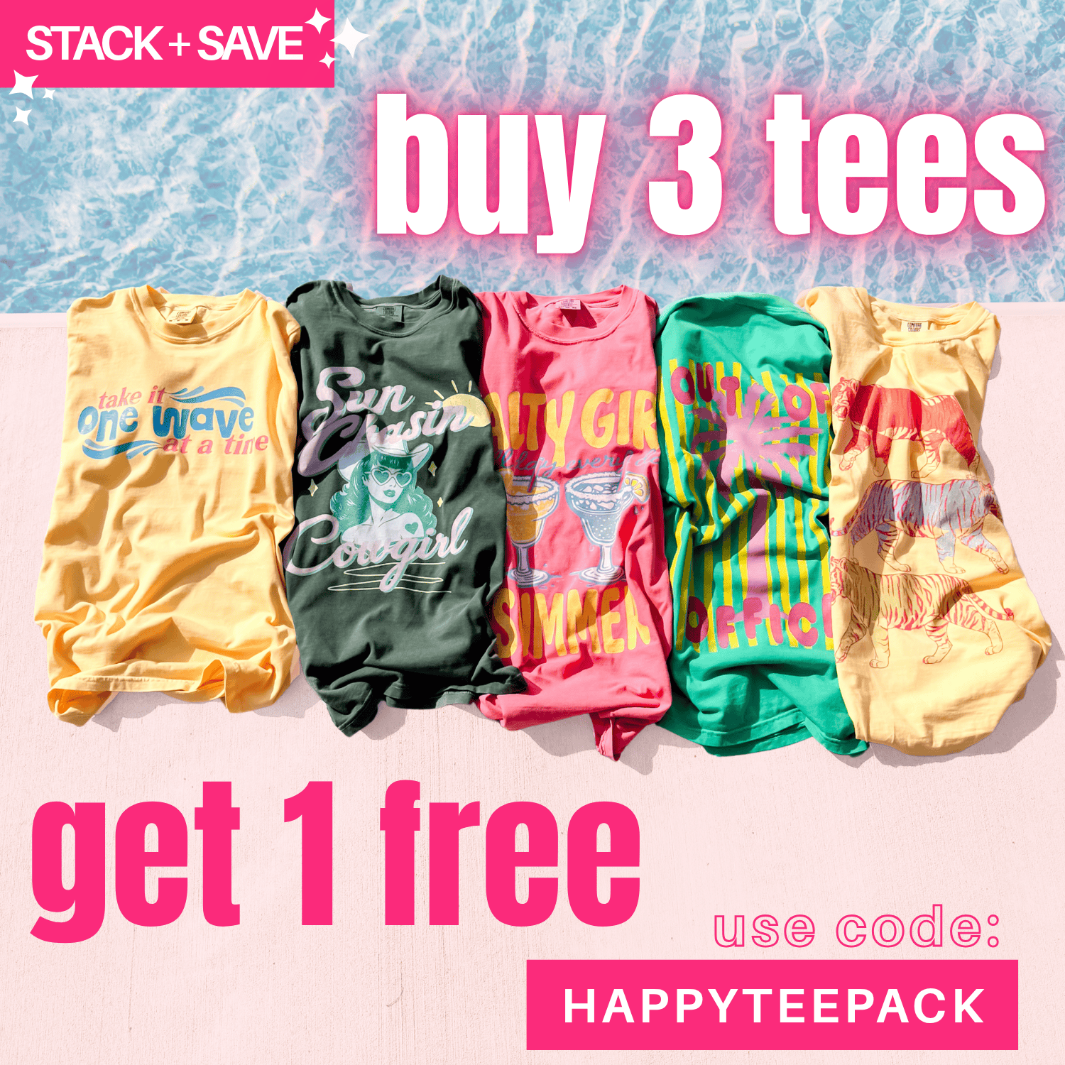 Salty Girl Summer Tee in pink, displayed among other colorful tees on a sandy beach background.