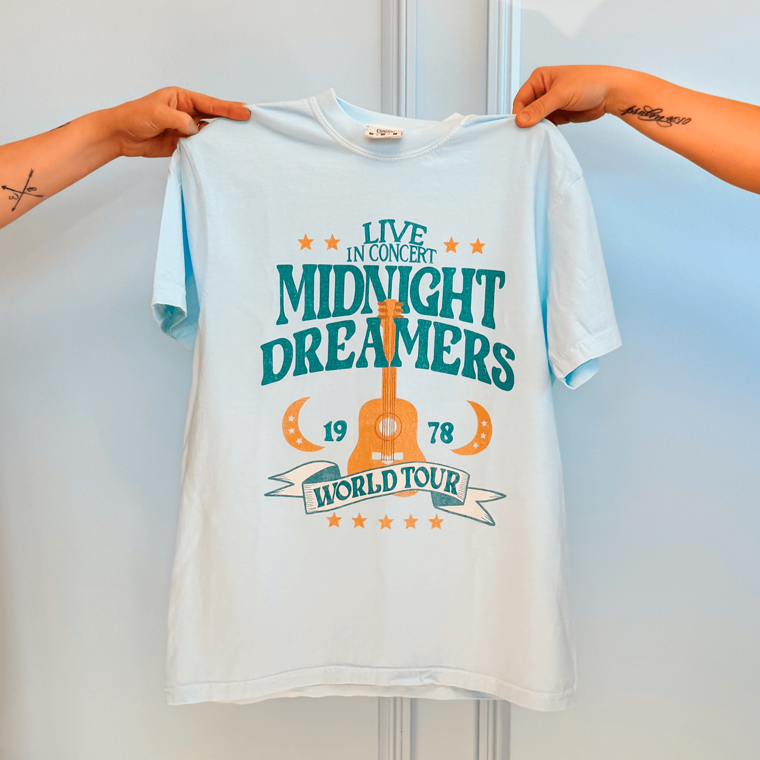 Midnight Dreamers Tee being held
