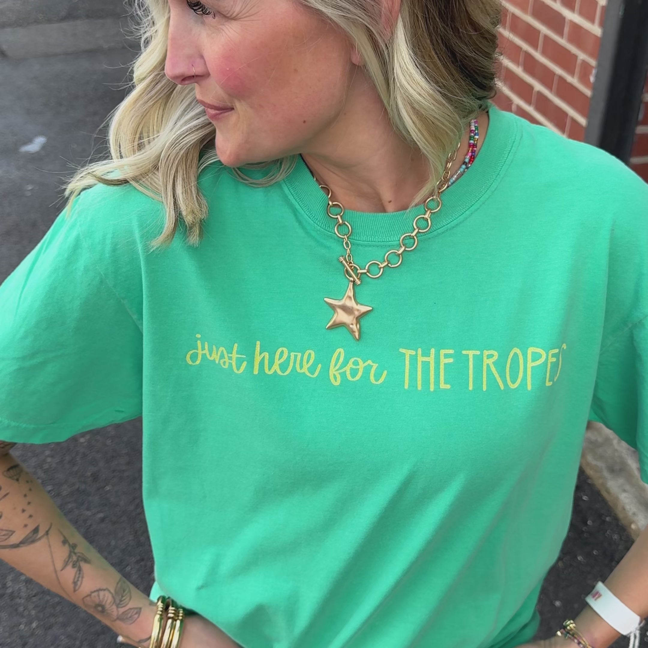 woman wearing for the tropes tee