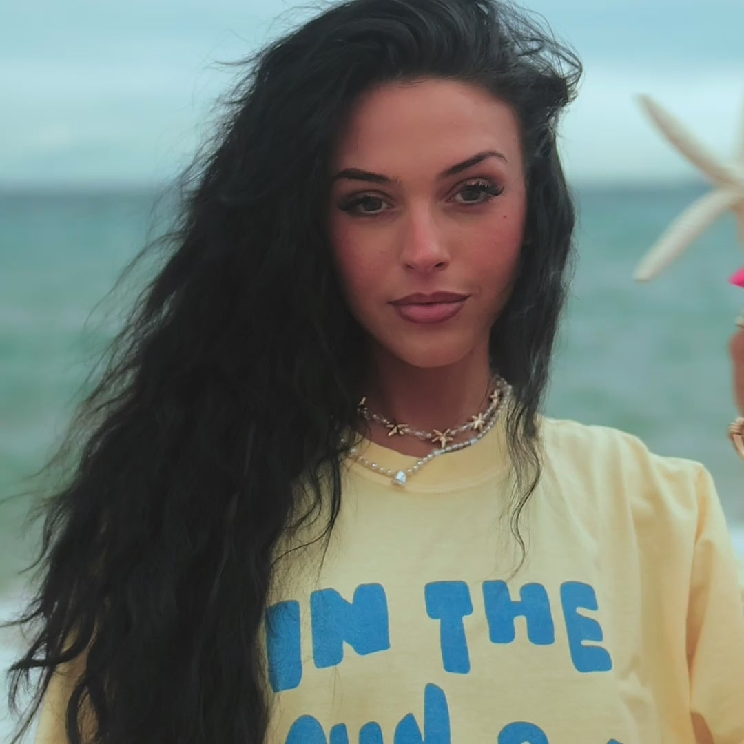 model wearing by the sea tee